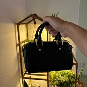 Nano size black leather handbag